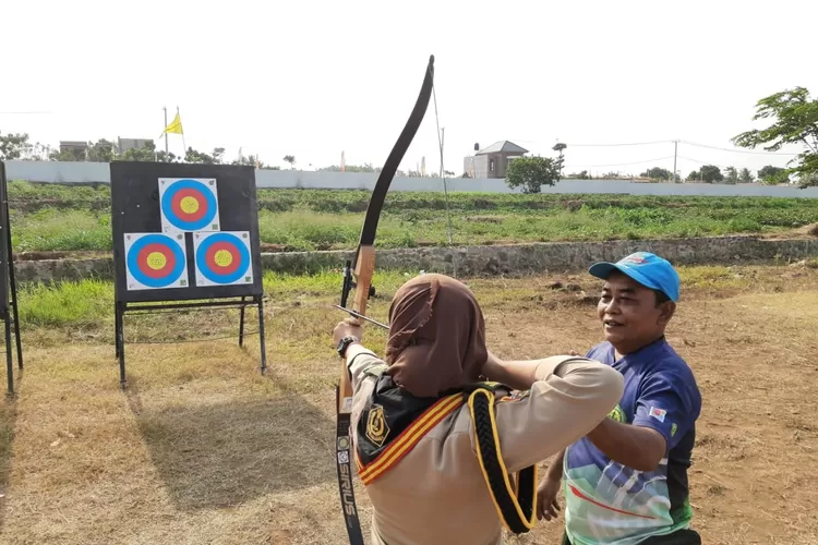 DIAJARKAN: Seorang peserta Jamcab VI Gerakan Pramuka Kota Bogor tengah diajarkan bagaimana cara memanah yang benar.