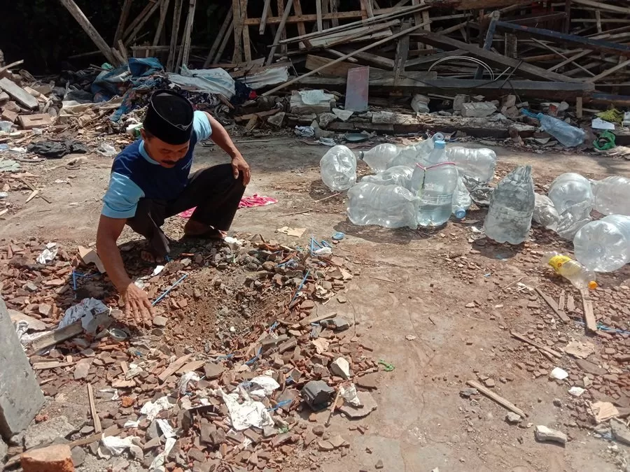 Sebuah lobang di tanah, yang diduga sebagai titik ledakan, ditemukan di rumah bagian belakang. (foto: Thoha)
