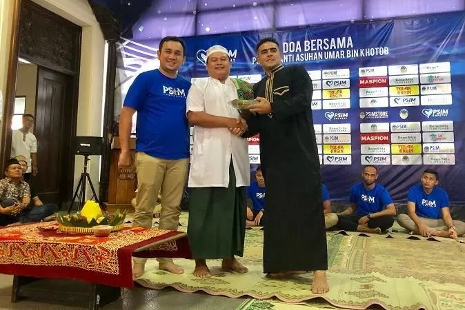 El Loco memberikan tumpeng pada perwakilan panti asuhan Umar Bin Khotob bersama manajer PSIM. (Foto: Harminanto)