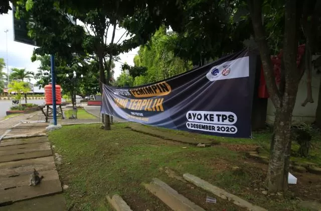 IMBAUAN: Spanduk ajakan datang ke TPS pada 9 Desember esok terikat ke pohon di kawasan bundaran Simpang Empat Banjarbaru.