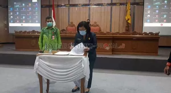 PARIPURNA : Ketua DPRD Kotim Rinie Anderson menandatangani pengesahan APBD Kotim 2021, Kamis (26/11).( RADO/RADAR SAMPIT)