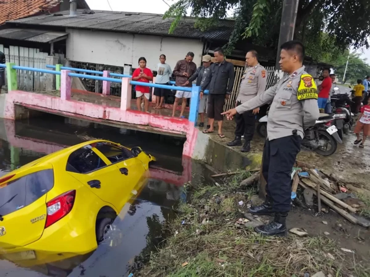 Mobil Anggota Polisi Berakhir Nyemplung ke Kali setelah tabrak lari pengendara motor (Foto : Humas Polres Karawang)