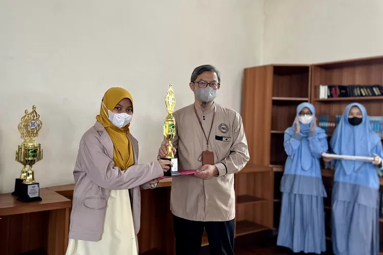 Saista Tanisa Rahayu mengenakan seragam kebanggan pesantren Persatuan Islam ketika menerima piala juara 1 lomba MTQ 