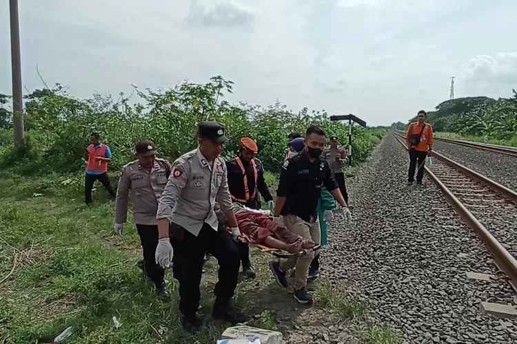  Petugas Polsek Kaliwungu memeriksa korban yang tergeletak di pinggir rel KA Desa Sumberejo akibat tertampar KA Ceremai Sabtu 04 februari 2023.  ((edi prayitno/kontributor Kendal))