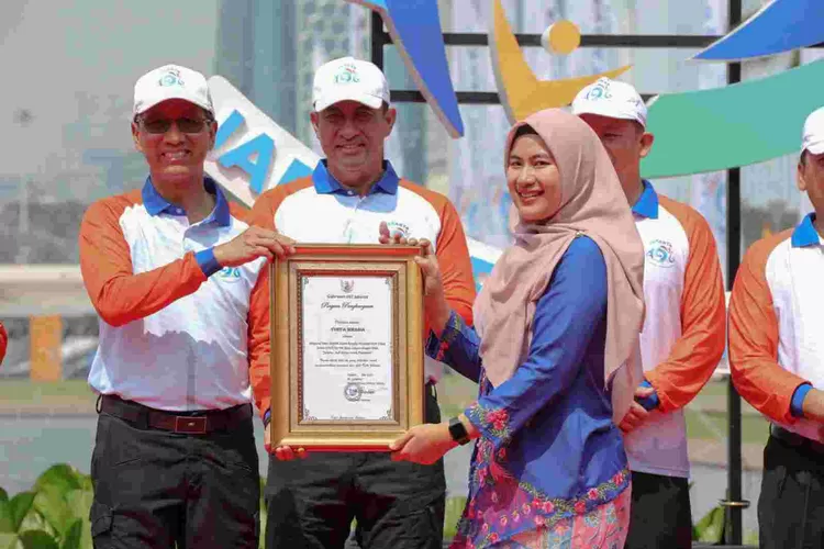 Sekda Provinsi DKI Jakarta  Joko  Agus Setyono menyerahkan penghargaan kepada Yunita Irmania atas ide yang diberikan dan terpilih sebagai tema HUT Jakarta tahun ini.
