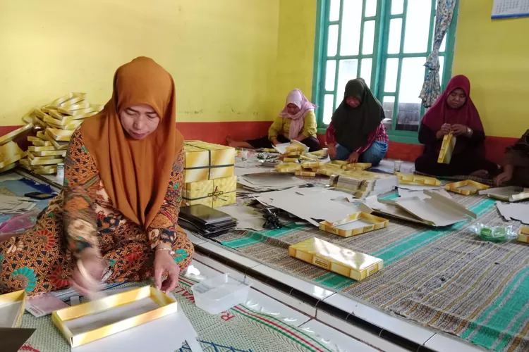 Emak-emak KUB Telaga Rejeki saat merakit box sarung milik PT Sukorintex Sebuah perusahaan penghasil sarung Wadimor. (Dok)