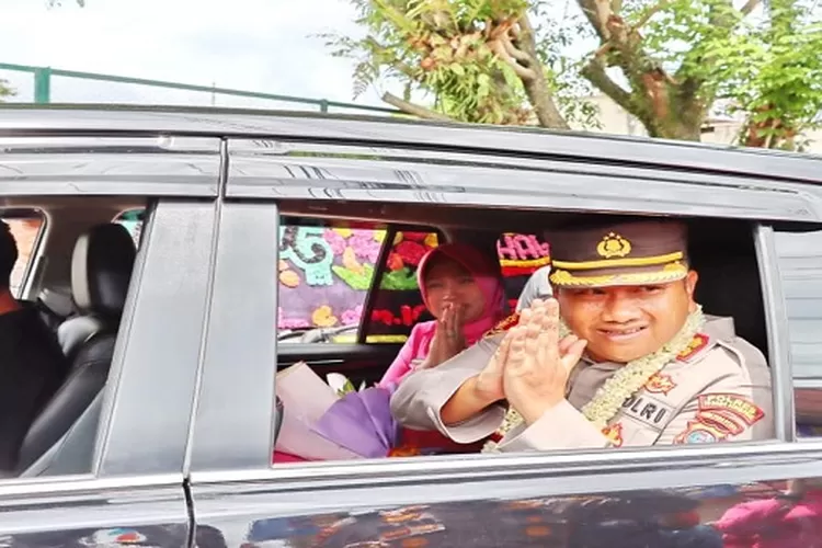 Mantan Kapolres Padangsidimpuan AKBP. Dwi Prasetyo Wibowo dan istri, melambaikan tangan dari dalam mobil saat meninggalkan Mapolres Padangsidimpuan  (Realitasonline.id/Riswandy)