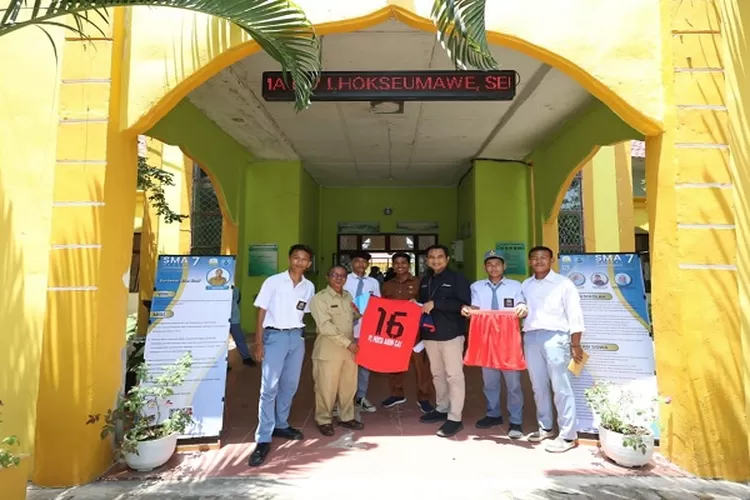 Manager Corcomm &amp; CSR, Iskandarsyah menyerahkan pakaian olahraga diterima Kepala SMAN 7 Lhokseumawe  (Realitasonline.id/Dok)