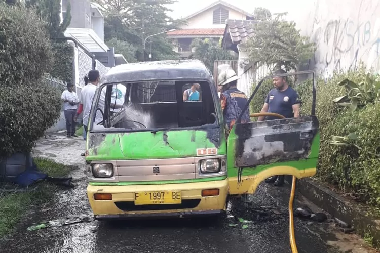 CEK: Petugas Damkar Kota Bogor mengecek angkot jurusan 06 yang terbakar diduga akibat korsleting listrik.