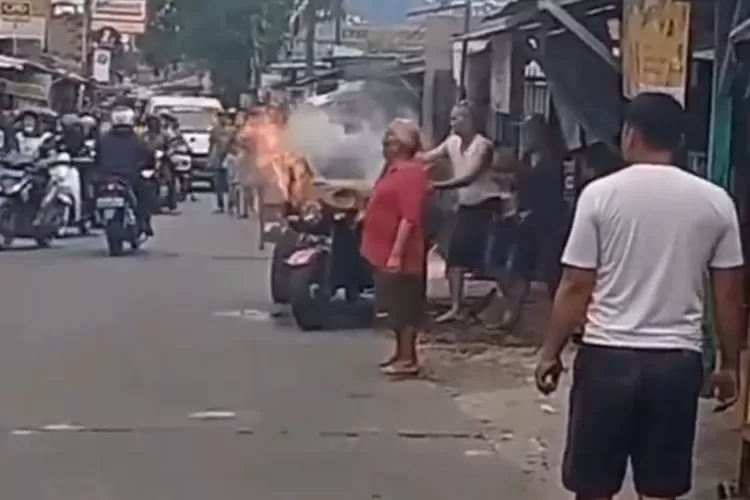 TERBAKAR : Tangkapan layar rekaman video motor roda tiga yang terbakar di depan rumah makan padang, Jalan Raya Cagar Alam, RT5/2, Kelurahan Pancoranmas, Kecamatan Pancoranmas Kota Depok, Jumat (16/12). ISTIMEWA