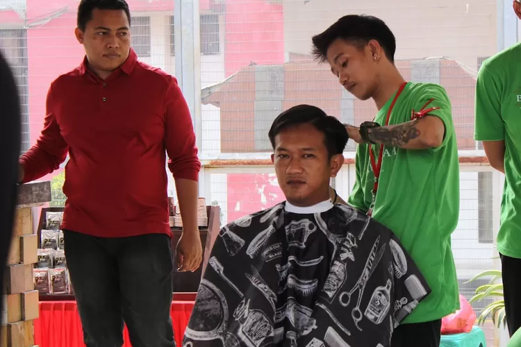 Kepala KPR Rutan Depok, Numan Fauzi (baju merah) mengawasi langsung kegiatan pangkas rambut kepada WBP, Jumat (4/8). (Rutan Depok )